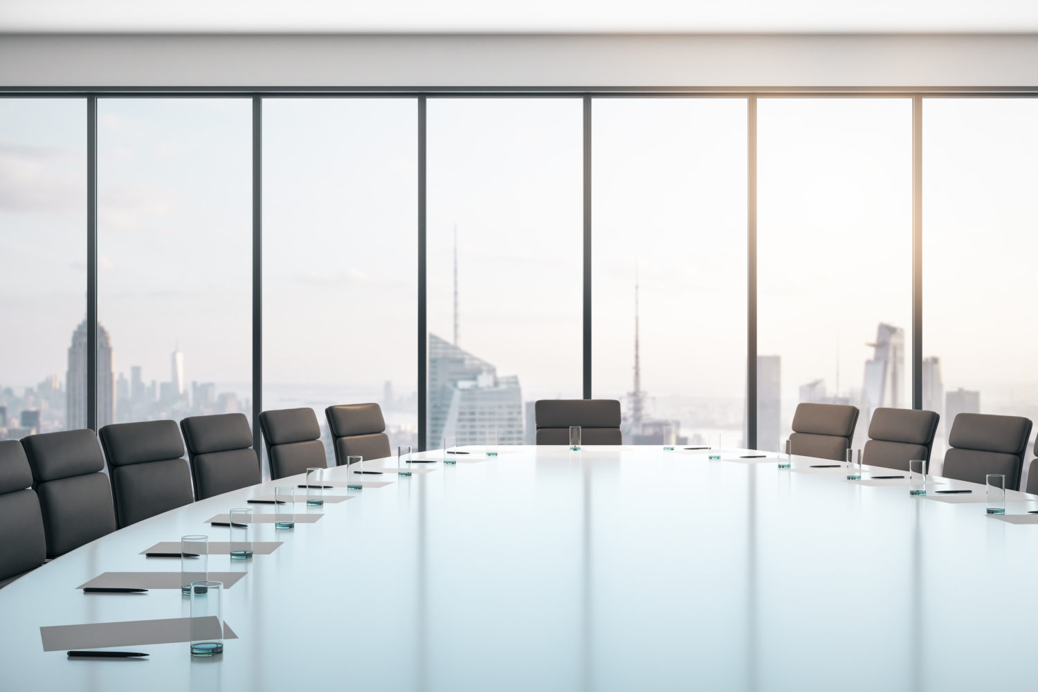 Conference room with table and chairs, large window and city view at sunrise, business concept