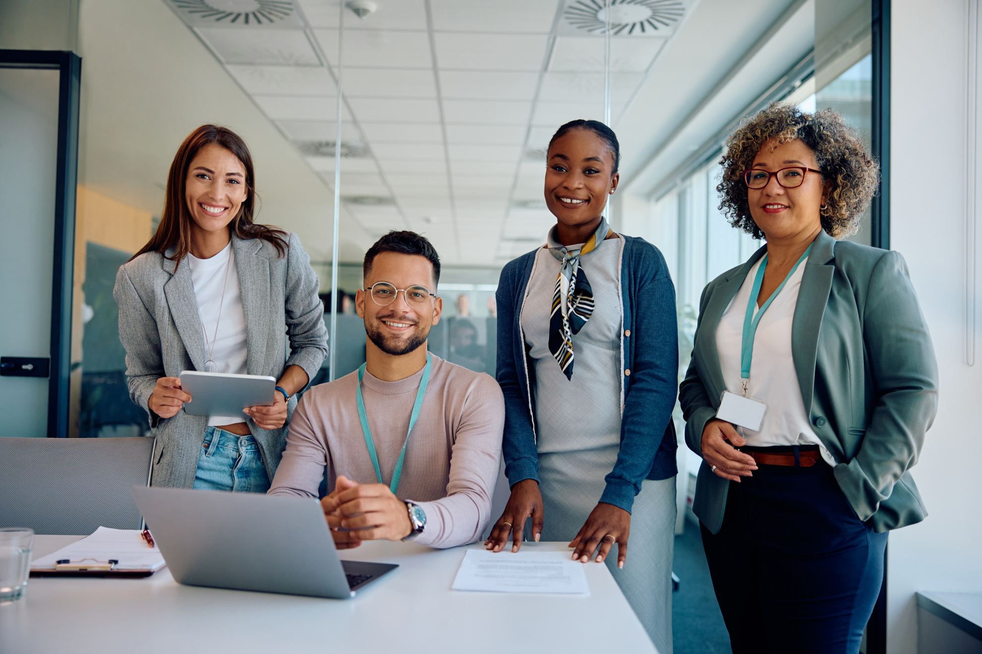 Happy multiracial business team working in the office and looking at camera